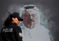 FILE - In this Oct. 2, 2019 file photo, a Turkish police officer walks past a picture of slain Saudi journalist Jamal Khashoggi prior to a ceremony, near the Saudi Arabia consulate in Istanbul, marking the one-year anniversary of his death. A court in Saudi Arabia has sentenced five people to death for the killing of Washington Post columnist Jamal Khashoggi, who was murdered in the Saudi Consulate in Istanbul in October 2018 by a team of Saudi agents. Saudi Arabia's state TV reported Monday, Dec. 23, 2019 that three others were sentenced to prison. All can appeal the verdicts. (AP Photo/Lefteris Pitarakis, File)