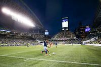 Oct 9, 2021; Seattle, Washington, USA; Vancouver Whitecaps forward Brian White (24, left) clears ball from Seattle Sounders FC midfielder Kelyn Rowe (22) during the second half at Lumen Field. Mandatory Credit: Joe Nicholson-USA TODAY Sports