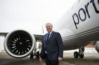 CEO of Porter Airlines Michael Deluce poses for a photograph with thee Embraer E195-E2 before it’s inaugural flight from Pearson Airport during a flight preview in Toronto, on Friday Jan. 27, 2023. (Christopher Katsarov/The Globe and Mail)