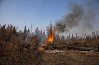 Small spot fires continued to flare up alongside Northwest Territories highways leading into Hay River, Fort Smith and Yellowknife, Friday, Sept. 15, 2023. THE CANADIAN PRESS/Bill Braden