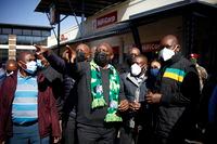 South African President Cyril Ramaphosa, on a visit to Soweto, South Africa, Sunday July 18 2021. Ramaphosa went to Johannesburg's Soweto township to view badly damaged retail centers where people were trampled to death in rioting sparked by the imprisonment of former President Jacob Zuma. (AP Photo/Oupa Nkosi)