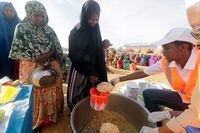 Local NGO prepare Iftar food for people at an internally displaced people camp on the outskirts of Mogadishu, Somalia, Friday, ‎March ‎24, ‎2023. This year's holy month of Ramadan coincides with the longest drought on record in Somalia. (AP Photo/Farah Abdi Warsameh)