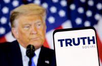 FILE PHOTO: The Truth social network logo is seen on a smartphone in front of a display of former U.S. President Donald Trump in this picture illustration taken February 21, 2022. REUTERS/Dado Ruvic/Illustration/File Photo/File Photo