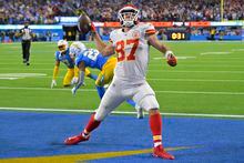 Kansas City Chiefs tight end Travis Kelce, right, celebrates a touchdown as Los Angeles Chargers safety Derwin James Jr., left, and cornerback Bryce Callahan get up off the ground during the second half of an NFL football game Sunday, Nov. 20, 2022, in Inglewood, Calif. (AP Photo/Jayne Kamin-Oncea)