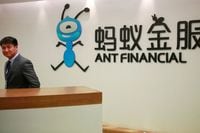 An employee stands next to the logo of Ant Financial Services Group, Alibaba's financial affiliate, at its headquarters in Hangzhou, Zhejiang province, China January 24, 2018.