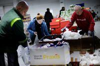 Ukrainian volunteers prepare to deliver food inside a complex, set up as a shelter, amid Russia's invasion of Ukraine, in Zaporizhzhya, Ukraine, April 13, 2022. REUTERS/Ueslei Marcelino