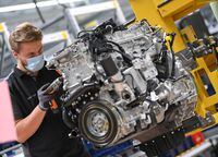 FILE PHOTO: A worker assembles an engine for a Mercedes-Benz S-class model at the Daimler Powertrain plant in Bad Cannstatt, as the spread of the coronavirus disease (COVID-19) continues near Stuttgart, Germany, April 22, 2020. REUTERS/Andreas Gebert/File Photo