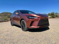 The flared spindle grille on the redesigned 2023 Lexus RX grows larger, extending to the front bumper.