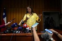 Judge Paola Plaza speaks to reporters after receiving a report by international forensic experts regarding the cause of death of Chilean poet Pablo Neruda, in Santiago, Chile, Wednesday, Feb. 15, 2023. (AP Photo/Esteban Felix)