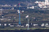 FILE - Flags of North Korea, rear, and South Korea, front, flutter in the wind as pictured from the border area between two Koreas in Paju, South Korea, on Aug. 9, 2021. South Korea said Monday, Nov. 6, 2023, it plans to launch its first domestically built spy satellite at the end of this month as part of its efforts to better monitor rival North Korea and deter its potential aggressions.(Im Byung-shik/Yonhap via AP, File)
