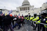 FILE - Violent insurrectionists loyal to President Donald Trump try to break through a police barrier on Jan. 6, 2021, at the Capitol in Washington. (AP Photo/Julio Cortez, File)