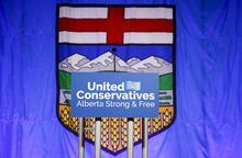 A United Conservative Party of Alberta's sign is shown in front of the Alberta flag before the party's leadership announcement in Calgary on Thursday, Oct. 6, 2022. The UCP says it will continue to invest in health care to fix the massive problems inherited from the former NDP government. THE CANADIAN PRESS/Jeff McIntosh