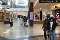 People at the Square One Shopping Centre in Mississauga, Ont. are photographed on Jan 4, 2022. Fred Lum/The Globe and Mail.  Provincial mandates effective Jan 5 will see mall capacities reduced to 50%.