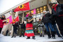 Sue Caribou, centre, sings a song in front of Winnipeg City hall during a rally, Thursday, Dec. 15, 2022, to call on the city to cease dumping operations at Brady landfill and conduct a search for the remains of missing and murdered indigenous women believed to be buried there. THE CANADIAN PRESS/Daniel Crump