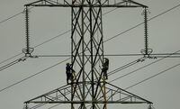 FILE PHOTO: Workers paint an electricity pylon near Lymm, northern England February 18, 2015.REUTERS/Phil Noble