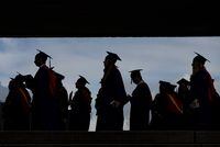 Graduates are silhouetted as they line up for a convocation ceremony at Simon Fraser University, in Burnaby, B.C., on Friday, May 6, 2022. THE CANADIAN PRESS/Darryl Dyck
