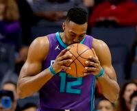 In this April 8, 2018, file photo, Charlotte Hornets' Dwight Howard kisses the basketball before the start of an NBA basketball game against the Indiana Pacers in Charlotte, N.C.