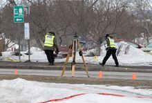 Police officers check the scene of a fatal crash, Tuesday, March 14, 2023 in Amqui Que. Two people were killed and nine others were injured Monday afternoon when a pickup truck plowed into pedestrians who were walking beside a road in the eastern Quebec town of Amqui. THE CANADIAN PRESS/Jacques Boissinot
