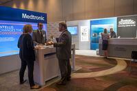 In this Saturday, Aug. 25, 2018 photo, sales representatives for Medtronic and Boston Scientific work their booths at the NYC Neuromodulation Conference in New York. For years, medical device companies and doctors have touted spinal cord stimulators as a panacea for millions of patients suffering from a wide range of intractable pain disorders. But the devices, surgically placed inside the back, that use electrical currents to block pain signals before they reach the brain _ are more dangerous than many patients understand, according to an Associated Press investigation. (AP Photo/Mary Altaffer)
