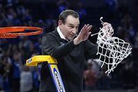 Duke head coach Mike Krzyzewski celebrates while cutting down the net after Duke defeated Arkansas in a college basketball game in the Elite 8 round of the NCAA men’s tournament in San Francisco, Saturday, March 26, 2022. (AP Photo/Marcio Jose Sanchez)