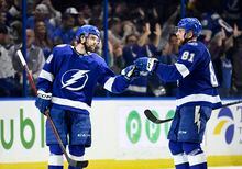 Tampa Bay Lightning left wing Brandon Hagel (38) and defenseman Erik Cernak (81) celebrate after Hagel's third goal of an NHL hockey game during the third period against the Montreal Canadiens Saturday, March 18, 2023, in Tampa, Fla. (AP Photo/Jason Behnken)