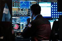 Traders work on the floor of the New York Stock Exchange (NYSE) on July 25.
