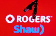 FILE PHOTO: Ethernet cables are seen in front of Rogers and Shaw Communications logos in this illustration taken, July 8, 2022. REUTERS/Dado Ruvic/Illustrations/File Photo