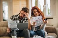 Worried couple feeling frustrated while have to pay their bills over Internet.
