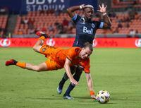 Sep 29, 2021; Houston, Texas, USA; Vancouver Whitecaps FC forward Cristian Dajome (11) reacts after colliding with Houston Dynamo FC midfielder Griffin Dorsey (25) during the second half at BBVA Stadium. Mandatory Credit: Troy Taormina-USA TODAY Sports