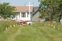 Flags mark the spot where the remains of over 750 children were buried on the site of the former Marieval Indian Residential School in Cowessess first Nation, Saskatchewan, June 25, 2021.hool in Cowessess First Nation, Saskatchewan, June 25, 2021. - More than 750 unmarked graves have been found near a former Catholic boarding school for indigenous children in western Canada, a tribal leader said Thursday -- the second such shock discovery in less than a month.
The revelation once again cast a spotlight on a dark chapter in Canada's history, and revived calls on the Pope and the Church to apologize for the abuse suffered at the schools, where students were forcibly assimilated into the country's dominant culture. (Photo by Geoff Robins / AFP) (Photo by GEOFF ROBINS/AFP via Getty Images)
