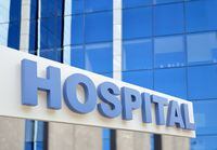 Hospital building sign closeup, with sky reflecting in the glass. 3d rendering