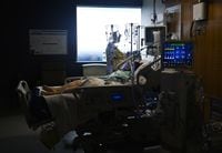 It may be harder for Ontario's health system to quickly respond to a future surge in critically ill COVID-19 patients, as non-virus care ramps up and workers contend with burnout, according to a new report. Registered nurse Claire Wilkinson tends to a 47-year-old woman who has COVID-19 and is intubated on a ventilator in the intensive care unit at the Humber River Hospital in Toronto on Tuesday, April 13, 2021.&nbsp;&nbsp;THE CANADIAN PRESS/Nathan Denette