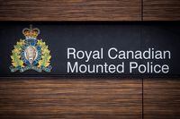 The RCMP logo is seen outside Royal Canadian Mounted Police "E" Division Headquarters, in Surrey, B.C., Friday ,April 13, 2018. RCMP in Alberta are warning people to be on the lookout for a newer BMW after they say there was a gunfight between one of its occupants and police east of Edmonton. THE CANADIAN PRESS/Darryl Dyck