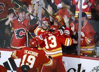 Calgary Flames forward Johnny Gaudreau (13) celebrates his goal with teammates during overtime NHL playoff hockey action against the Dallas Stars in Calgary, Alta., Sunday, May 15, 2022. THE CANADIAN PRESS/Jeff McIntosh
