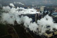 CORRECTS TO REMOVE THE REFERENCES TO CARBON BLACK AND STEEL MANUFACTURING - FILE - In this Nov. 28, 2019 file photo, smoke and steam rise from a coal processing plant in Hejin in central China's Shanxi Province. Scientists say greenhouse gas emissions must start dropping sharply as soon as possible to prevent global temperatures rising more than 1.5 degrees Celsius (2.7 degrees Fahrenheit) by the end of the century. So far, the world is on course for a 3- to 4-degree Celsius rise, with potentially dramatic consequences for many countries. (AP Photo/Sam McNeil, File)