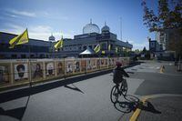 FILE - A man rides a bike outside the Guru Nanak Sikh Gurdwara Sahib in Surrey, British Columbia, on Monday, Sept. 18, 2023, where temple president Hardeep Singh Nijjar was gunned down in his vehicle while leaving the temple parking lot in June. (Darryl Dyck/The Canadian Press via AP, File)