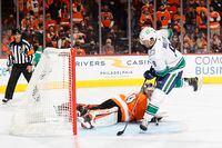 PHILADELPHIA, PENNSYLVANIA - OCTOBER 15: J.T. Miller #9 of the Vancouver Canucks scores past Carter Hart #79 of the Philadelphia Flyers during a penatly shootout at Wells Fargo Center on October 15, 2021 in Philadelphia, Pennsylvania. (Photo by Tim Nwachukwu/Getty Images)