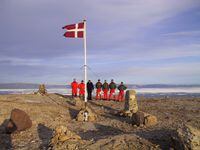 The crew of Danish warship Vedderen perform a flag raising ceremony on the uninhabitated Hans Island off northwestern Greenland, in this Aug. 13, 2002 file photo. A longtime mining geologist and developer has come up with his own solution to Canada's long-running Arctic sovereignty dispute with Denmark. (AP Photo/Polfoto, Vedderen, File) ** DENMARK OUT **