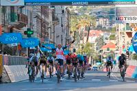 Belgium's Jasper Stuyven, center, crosses the finish line to win the Milan to Sanremo cycling race, in Sanremo, Italy, Saturday, March 20, 2021. (Gian Mattia D'Alberto/LaPresse via AP)