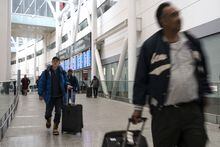 Passengers arrive at Pearson Airport in Mississauga, Ont. on Tuesday, March 14, 2023. THE CANADIAN PRESS/Chris Young