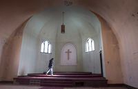 A woman walks through an abandoned church in Thunder Bay, Ont., Friday, March 4, 2016. Statistics Canada says 34.6 per cent of people in this country have no religious affiliation — more than ever before. THE CANADIAN PRESS/Paul Chiasson