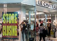 A woman in a face exits Le Chateau at the Guildford Town Centre in Surrey, B.C., Friday, Dec. 4, 2020. The clothing store is going out of business amid the global COVID-19 pandemic. THE CANADIAN PRESS/Marissa Tiel