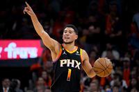 Phoenix Suns guard Devin Booker (1) calls a play against the Los Angeles Clippers during the second half of Game 5 of a first-round NBA basketball playoff series, Tuesday, April 25, 2023, in Phoenix. (AP Photo/Matt York)