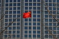 FILE PHOTO: A Chinese flag flutters outside the Chinese foreign ministry in Beijing, China February 24, 2022. REUTERS/Carlos Garcia Rawlins