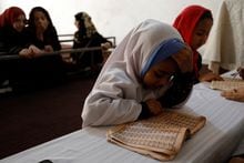 An Afghan girl reads the Koran in a madrasa or religious school in Kabul, Afghanistan, October 8, 2022. REUTERS/Ali Khara