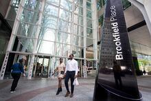 Pedestrians and office workers walk past the Bay St. entrance to Brookfield Place in Toronto’s Financial District on July 12, 2022. Fred Lum/The Globe and Mail. 