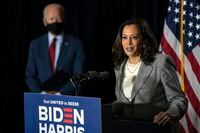 In this Aug. 13, 2020, file photo, Democratic presidential candidate Joe Biden stands at left as his running mate Sen. Kamala Harris, D-Calif., speaks at the Hotel DuPont in Wilmington, Del.