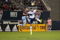 Sep 19, 2021; Commerce City, Colorado, USA; Colorado Rapids defender Keegan Rosenberry (2) and Vancouver Whitecaps FC forward Lucas Cavallini (9) battle for the ball in the second half at Dick's Sporting Goods Park. Mandatory Credit: Isaiah J. Downing-USA TODAY Sports