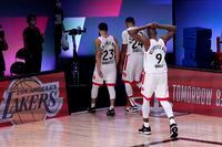 Toronto Raptors' Fred VanVleet (23), Norman Powell (24) and Serge Ibaka (9) head to the locker room after losing to the Boston Celtics during an NBA conference semifinal playoff basketball game Friday, Sept. 11, 2020, in Lake Buena Vista, Fla.