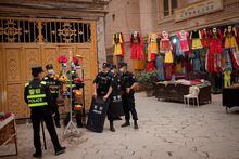 FILE PHOTO: Police officers stand guard in the old city in Kashgar, Xinjiang Uyghur Autonomous Region, China, May 3, 2021. Picture taken May 3, 2021. REUTERS/Thomas Peter